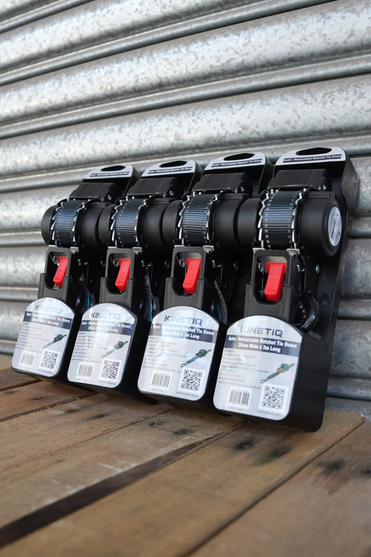Set of 4 KINETIQ automatic retractable ratchet straps, each 3m long and 25mm wide, with black and orange ratchet mechanisms.