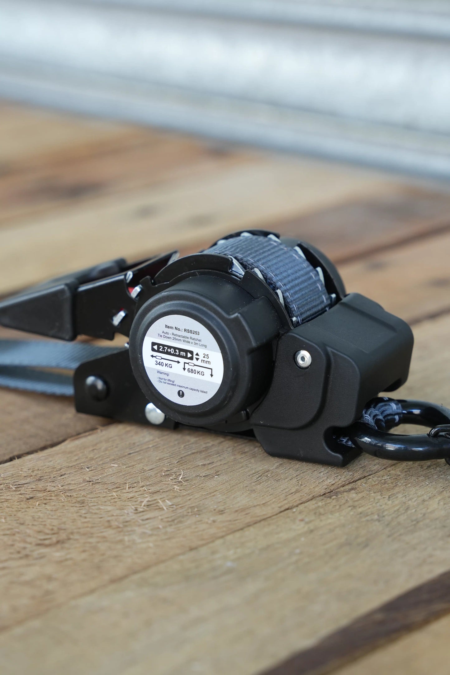 KINETIQ Automatic Retractable Ratchet Strap, 3m long and 25mm wide, with a black and orange ratchet mechanism and durable strap.