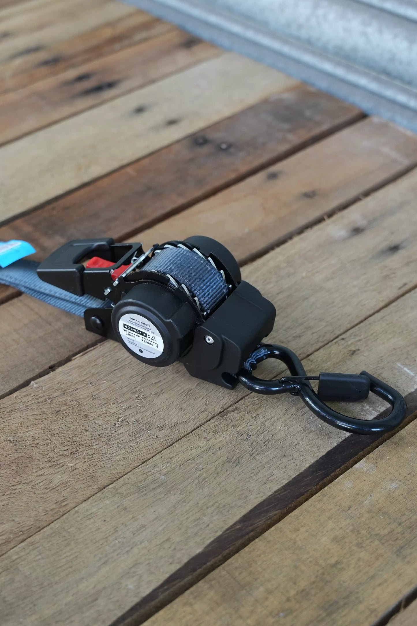 KINETIQ Automatic Retractable Ratchet Strap, 3m long and 25mm wide, with a black and orange ratchet mechanism and durable strap.