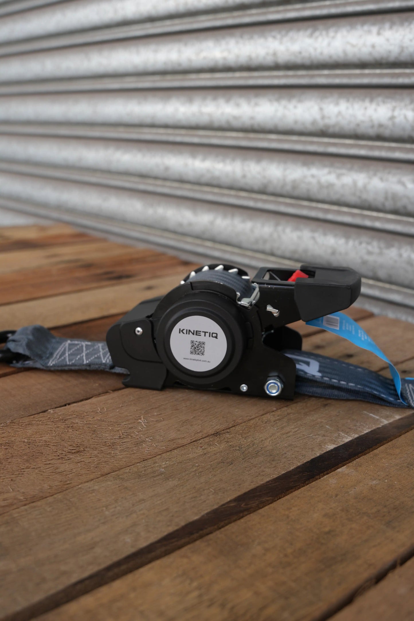 Set of 2 KINETIQ automatic retractable ratchet straps, each 4m long and 50mm wide, with black and orange components.