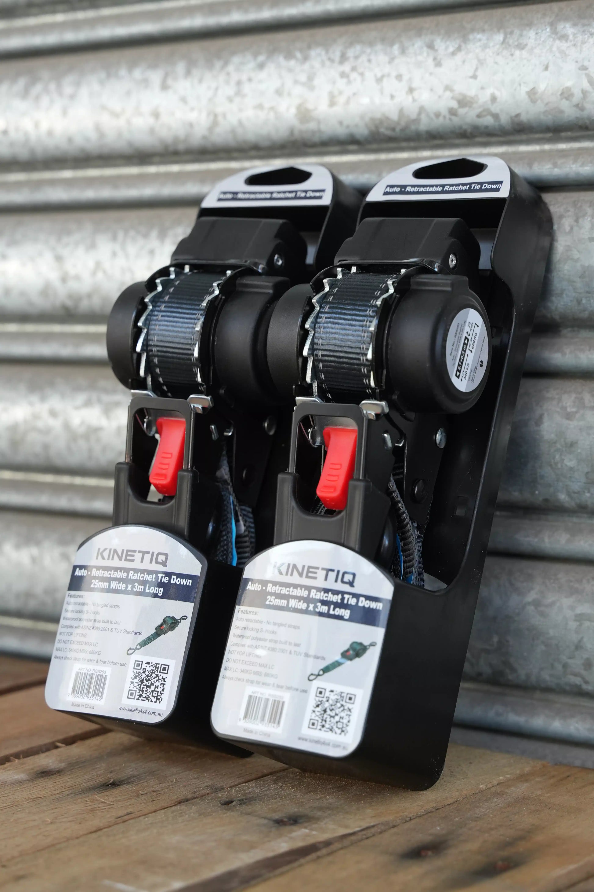 Set of 2 KINETIQ automatic retractable ratchet straps, each 3m long and 25mm wide, with black and orange components.