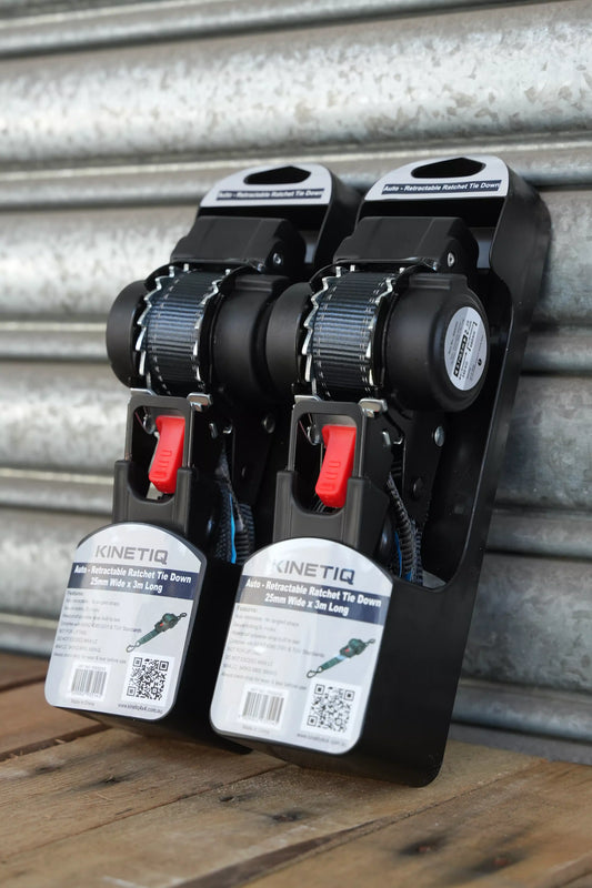 Set of 2 KINETIQ automatic retractable ratchet straps, each 3m long and 25mm wide, with black and orange components.