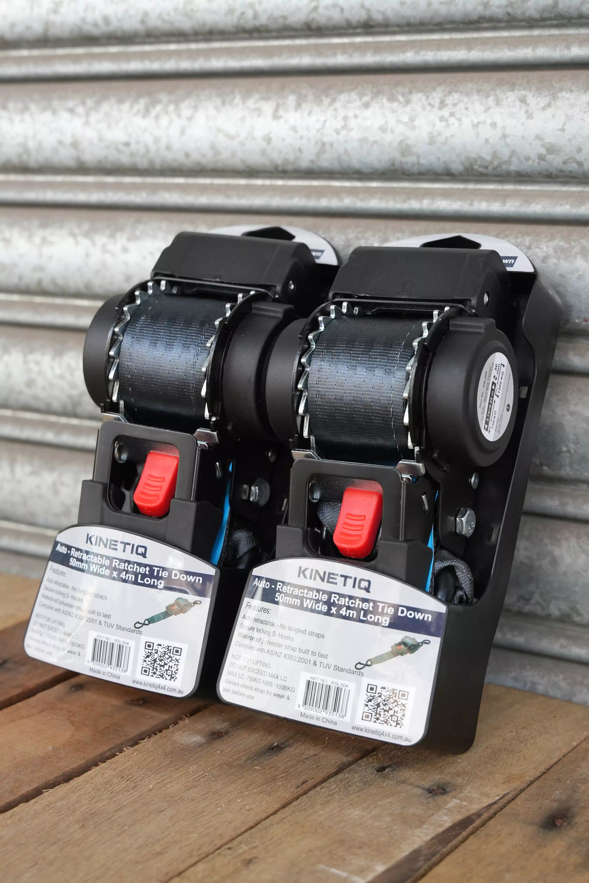 Set of 2 KINETIQ automatic retractable ratchet straps, each 4m long and 50mm wide, with black and orange components.