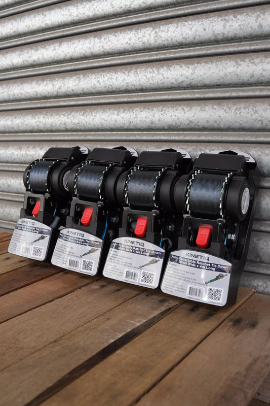 Set of 4 KINETIQ automatic retractable ratchet straps, each 4m long and 50mm wide, with black and orange components.