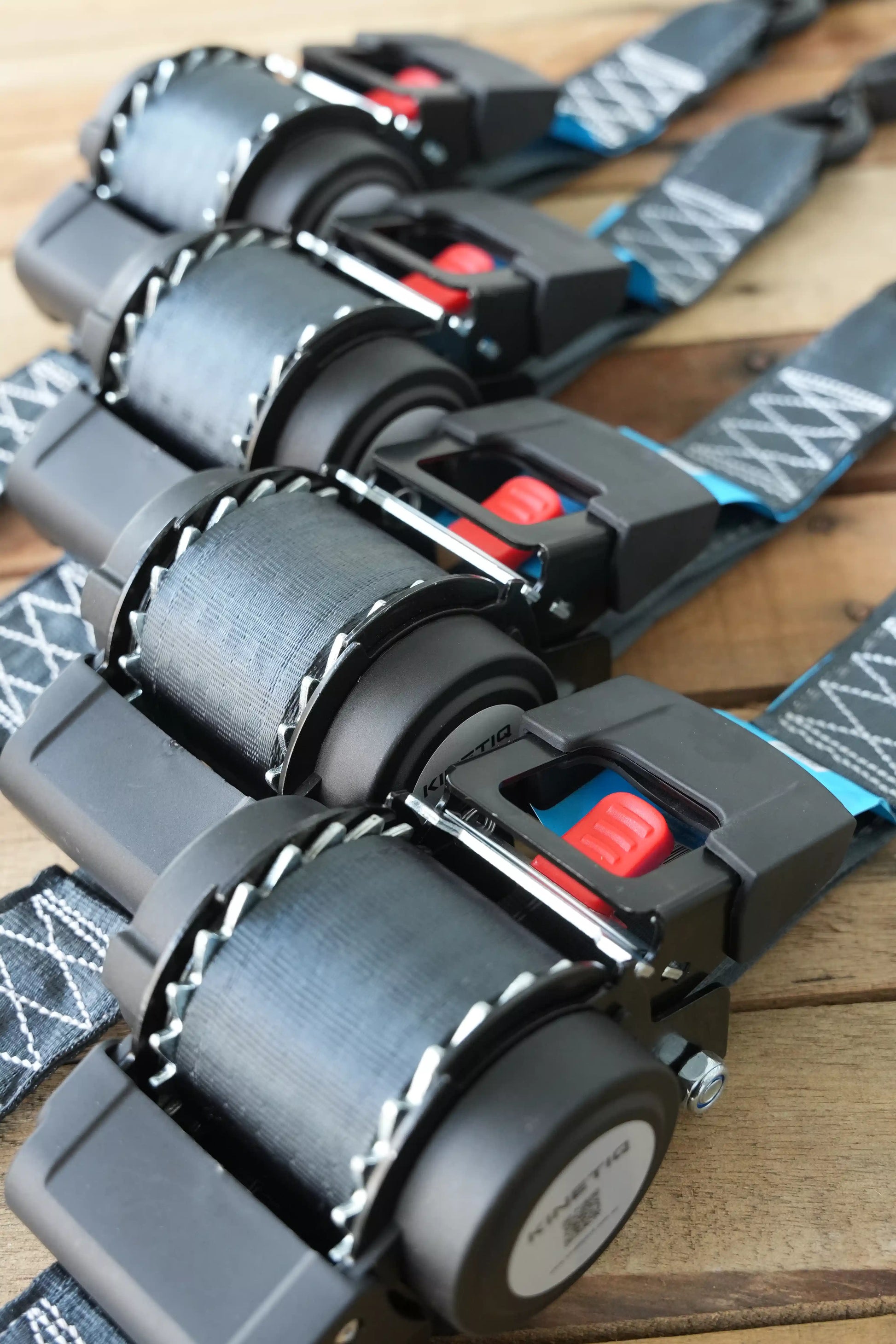 Set of 4 KINETIQ automatic retractable ratchet straps, each 4m long and 50mm wide, with black and orange components.